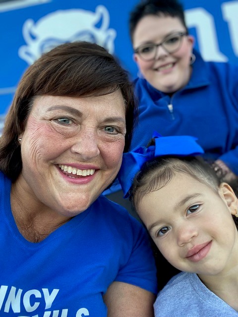 Angie with her family at a Blue Devil game