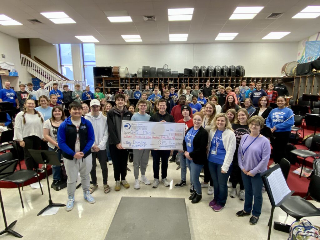 The QPSF staff along with Jeff Duffy and the QHS Band as they learn the news their grant was approved. 