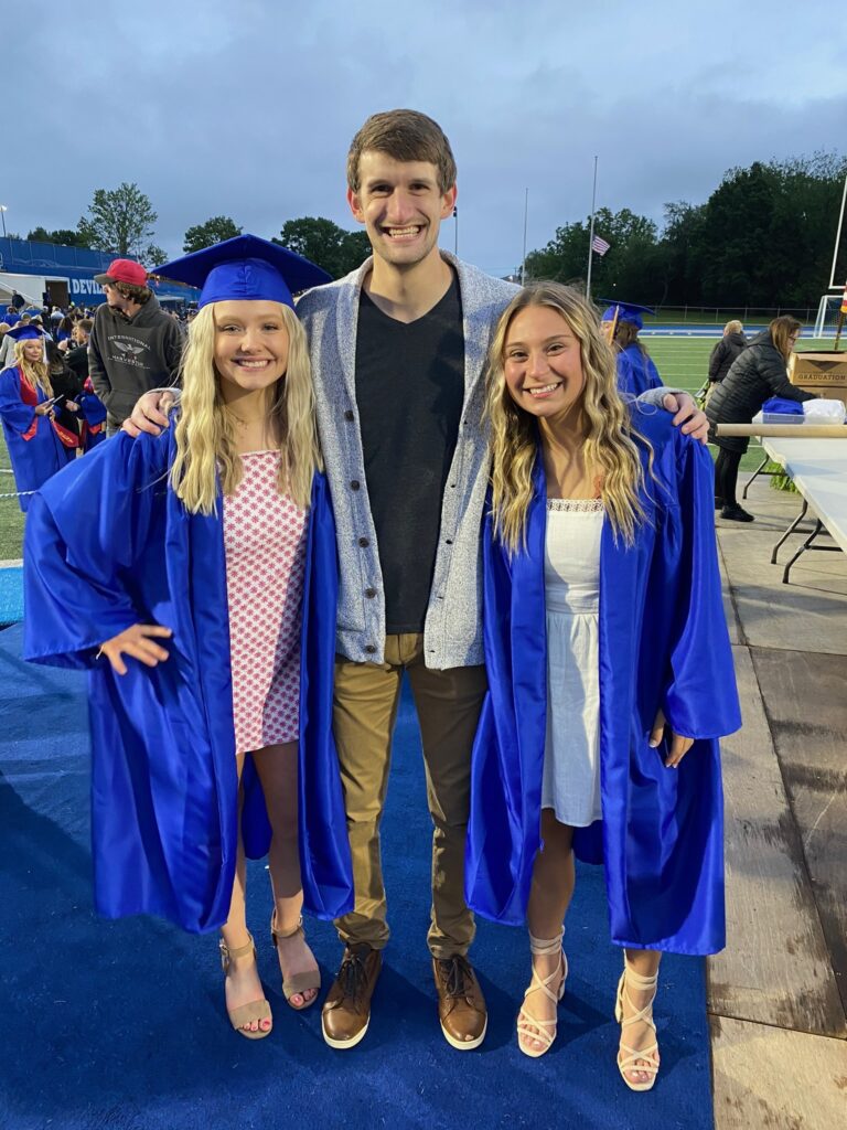 Maddie Hill, pictured at her QHS graduation ceremony with fellow graduate and QHS teacher Ben Dombroski (“Dombro”), 2021.