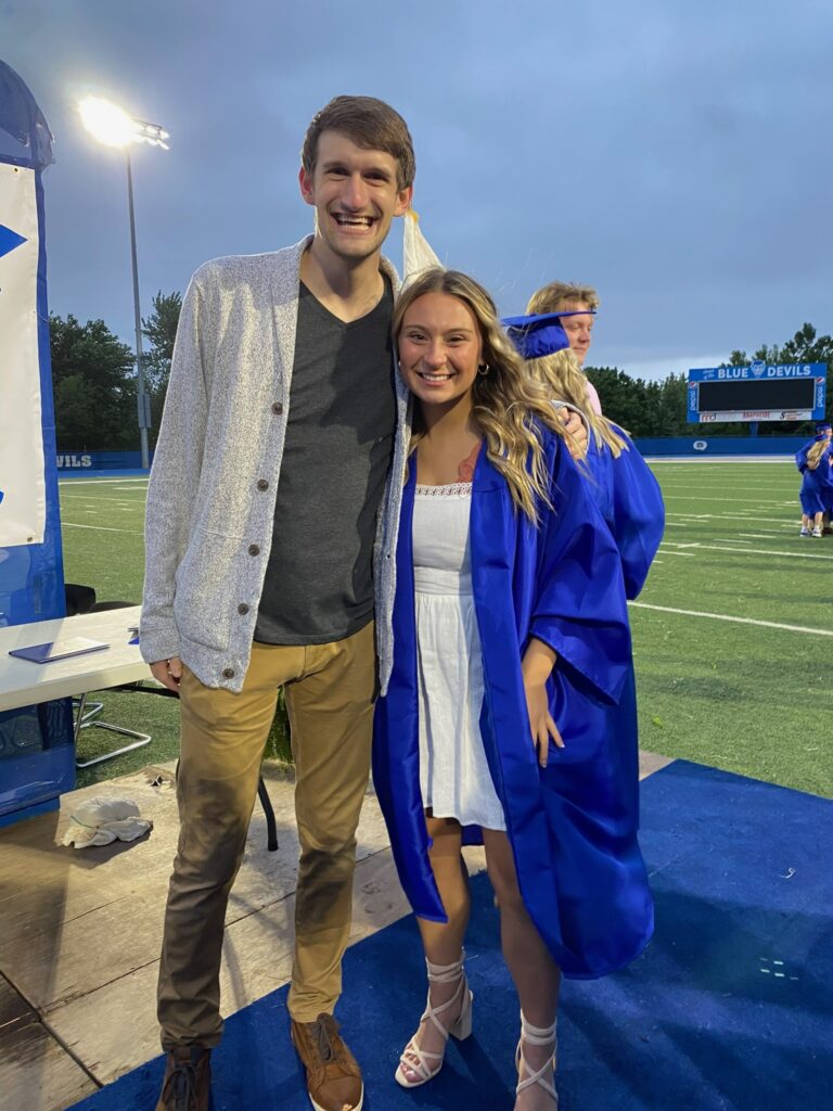 Maddie Hill, pictured at her QHS graduation ceremony with QHS teacher Ben Dombroski (“Dombro”), 2021.